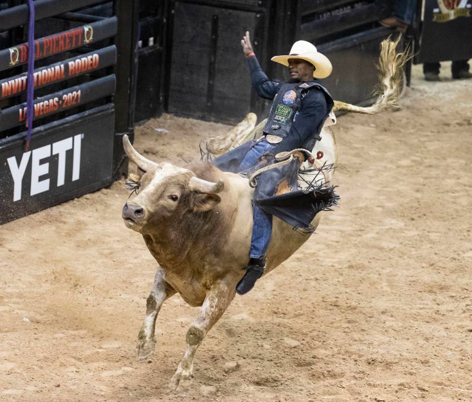 Winner of Bull Riding competition, Ouncie Mitchell, of Houston, Texas., rides Romeo while comp ...