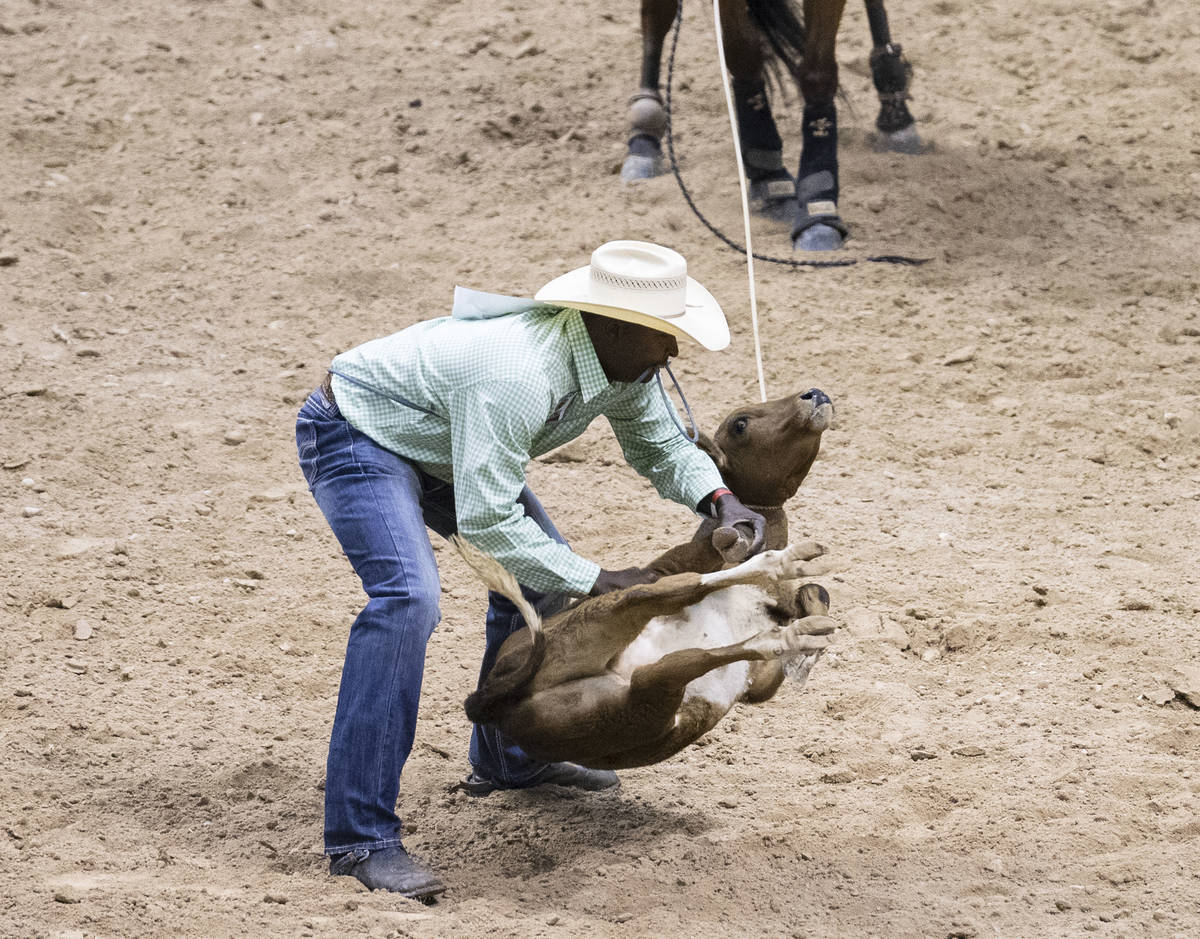 Chris Rolling, of Huntsville, Texas, participates in calf roping competition at the Bill Picket ...