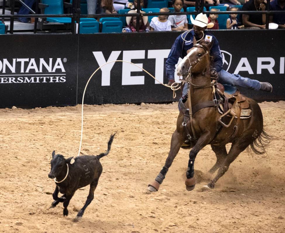 Jeremy Burkhalter, of Houston, Texas, participates in calf roping competition at the Bill Picke ...