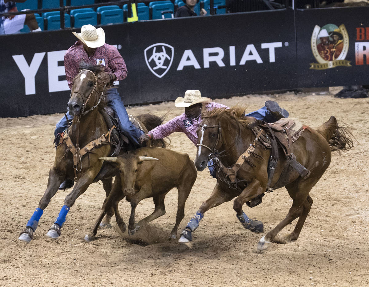 Troy Ford attempts to wrangle a calf at the Bill Pickett Invitational Rodeo final, the nation's ...