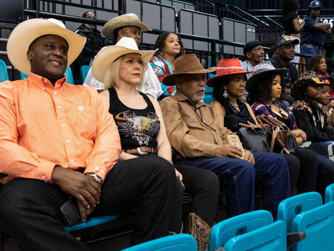 People, including Victor Locklin, left, Judy Santos, Darrell Porter and his wife Wanda watch th ...