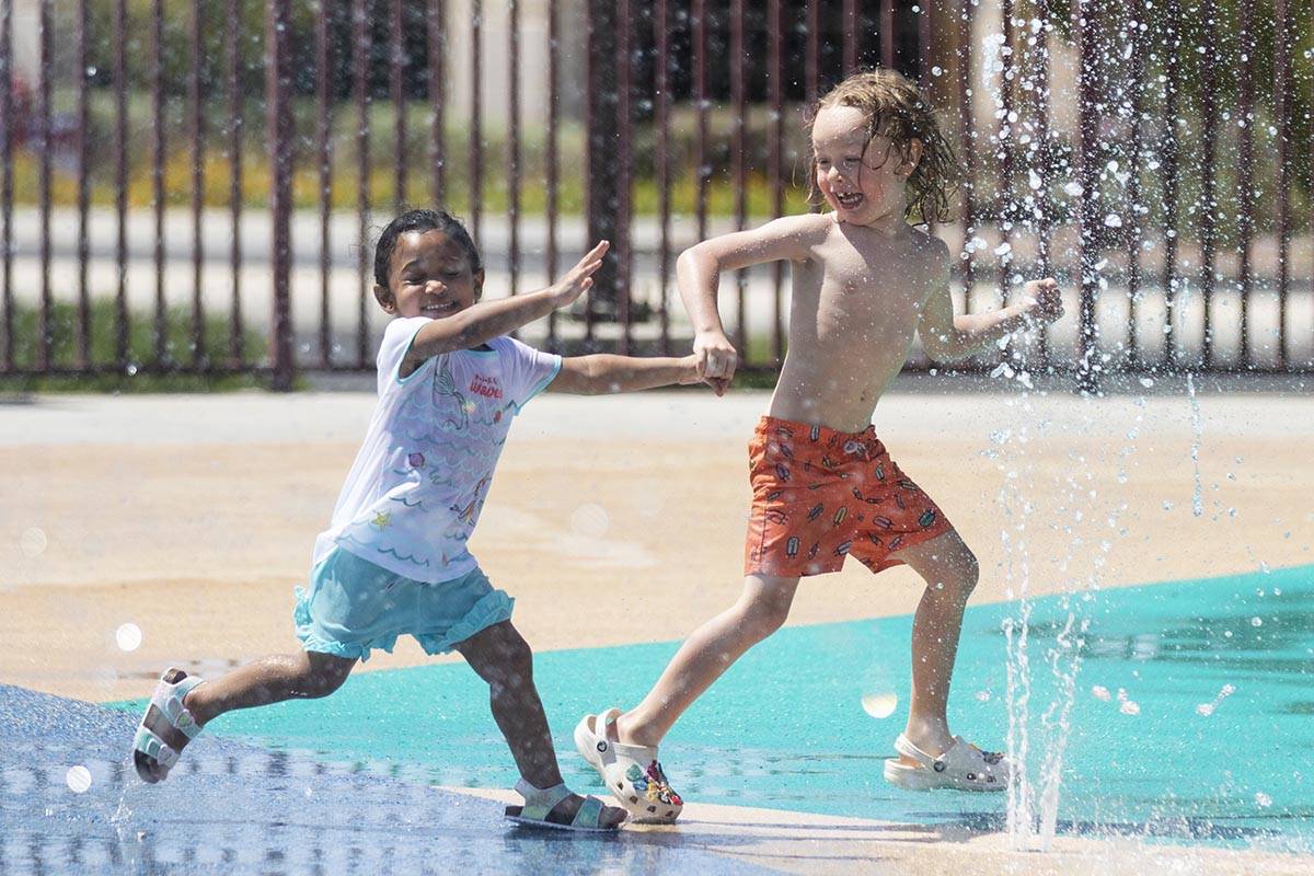 Heavynn Bradford, 2, left, plays with Zane Peters, 4, at Paseo Vista Park, on Wednesday, June 2 ...