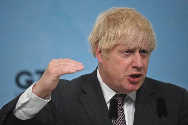 Britain's Prime Minister Boris Johnson gestures, during a press conference on the final day of ...