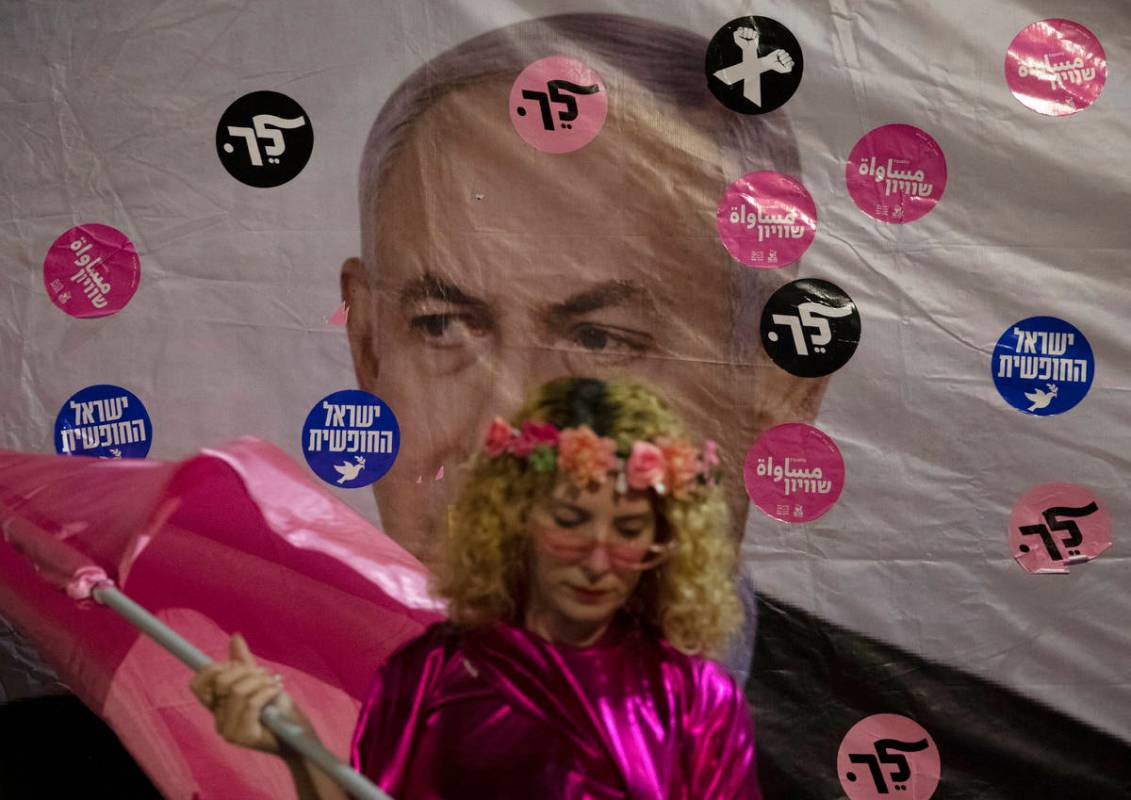 An Israeli protester wears pink during a demonstration against Israeli Prime Minister Benjamin ...