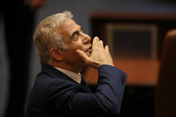 Israeli politician Yair Lapid of the Yesh Atid party sends greetings during a Knesset session i ...
