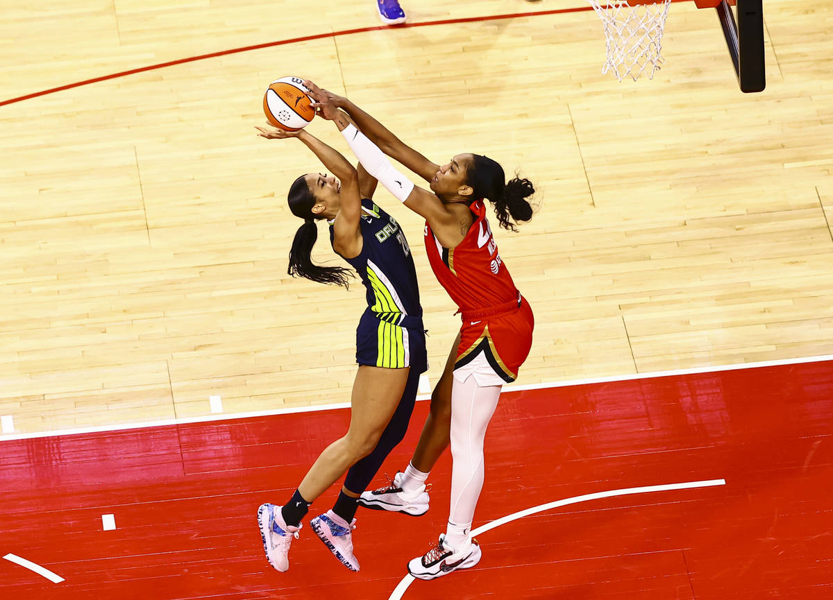 Las Vegas Aces' A'ja Wilson, right, blocks a shot from Dallas Wings' Isabelle Harrison during t ...