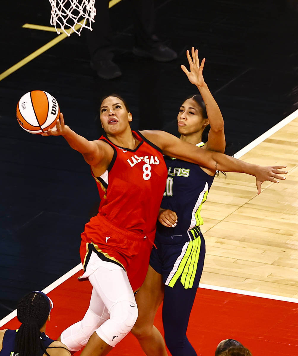 Las Vegas Aces' Liz Cambage (8) shoots in front of Dallas Wings' Isabelle Harrison (20) during ...