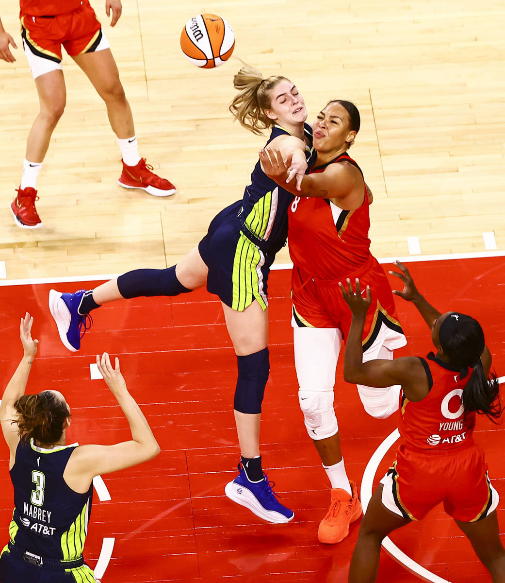 Dallas Wings' Bella Alarie (32) and Las Vegas Aces' Liz Cambage (8) battle for a rebound during ...