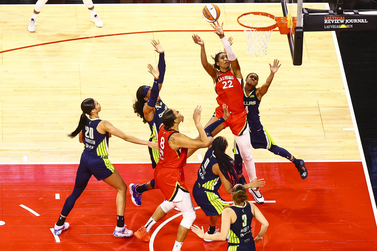 Las Vegas Aces' A'ja Wilson (22) shoots in front of Dallas Wings' Moriah Jefferson (4) during t ...