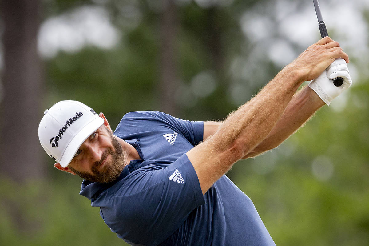 Dustin Johnson watches his drive off the third tee during the final round of the Palmetto Champ ...