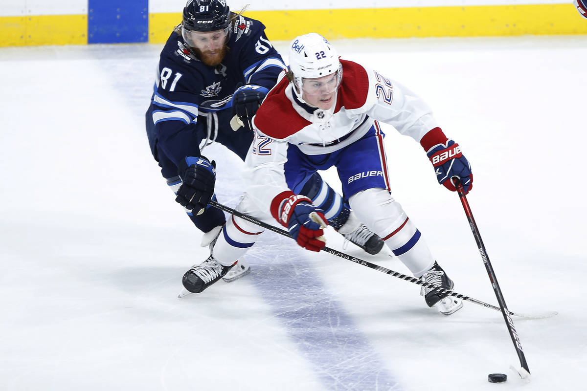 Winnipeg Jets' Kyle Connor (81) chases Montreal Canadiens' Cole Caufield (22) during the second ...