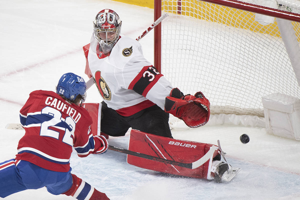 In this May 1, 2021, file photo, Montreal Canadiens' Cole Caufield scores against Ottawa Senato ...