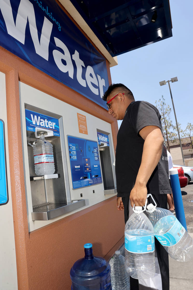 Jaime Juarez, 39, gets water at a kiosk on the corner of Smoke Ranch Road and Jones Boulevard M ...