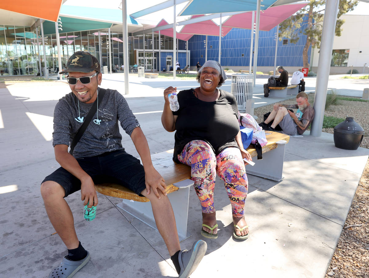 Ket Then, left, and Vaniqueka Dixon hydrate in the shade while waiting for the East Las Vegas L ...