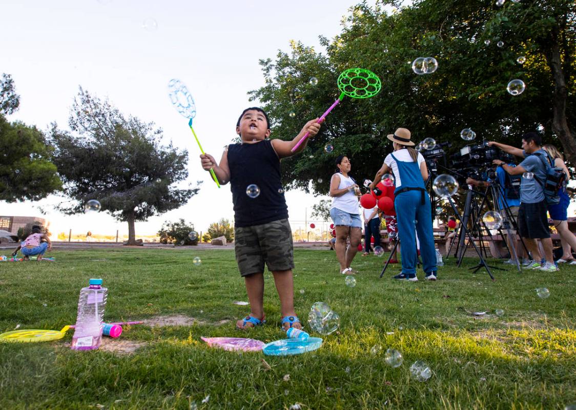 Aiden Trujillo-Maldonado, 3, of Las Vegas, plays with bubbles during a vigil in memory of Liam ...