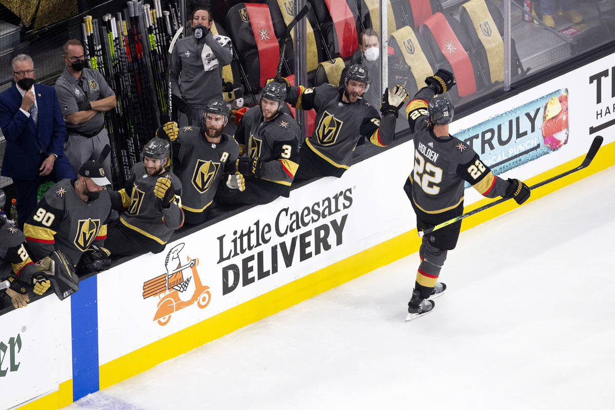 Golden Knights defenseman Nick Holden (22) is congratulated by his teammates after scoring a go ...