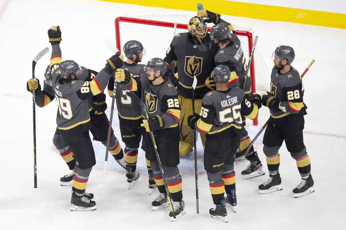 The Golden Knights congratulate each other and goaltender Marc-Andre Fleury (29) after they won ...