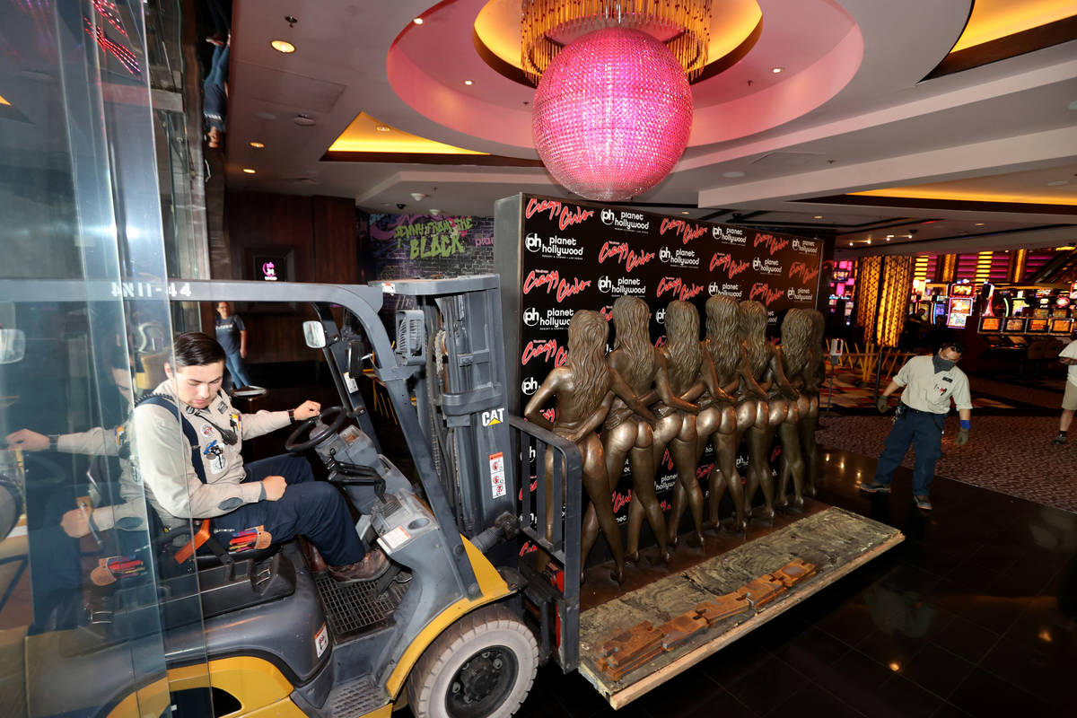 Workers move the "Crazy Girls" bronze statue from Planet Hollywood Resort, Tuesday, June 15, 20 ...