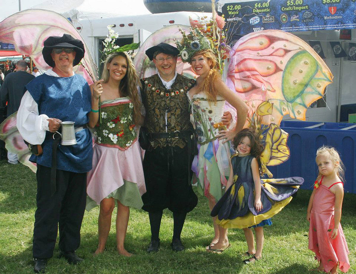 Nate Tannenbaum takes a photo with people dressed in fairy and medieval attire at the Age of Ch ...