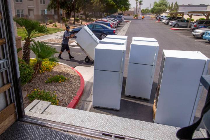 Lowe's employee Romanldo Lazaro prepares to take away some of the 98 old fridges at Bonanza Pin ...