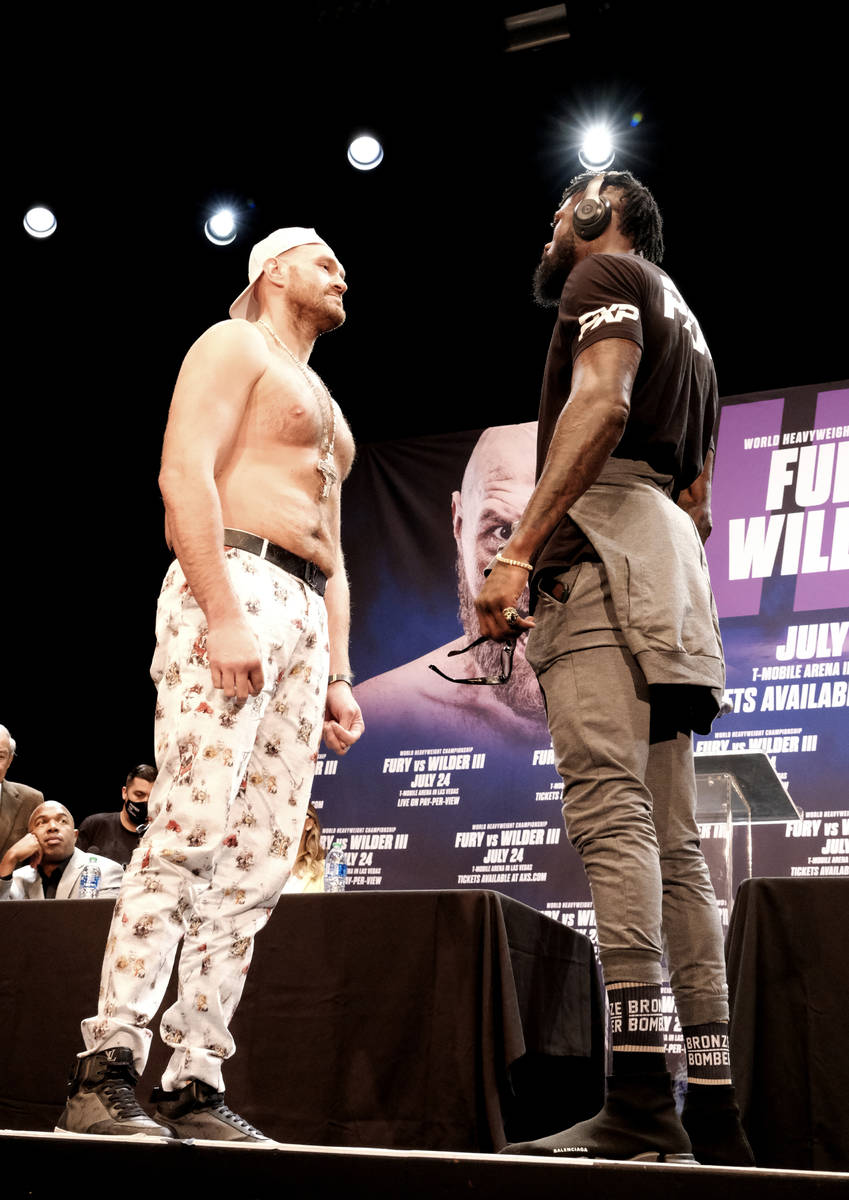 WBC Heavyweight Champion Tyson Fury, left and Deontay Wilder face off at a news conference in L ...
