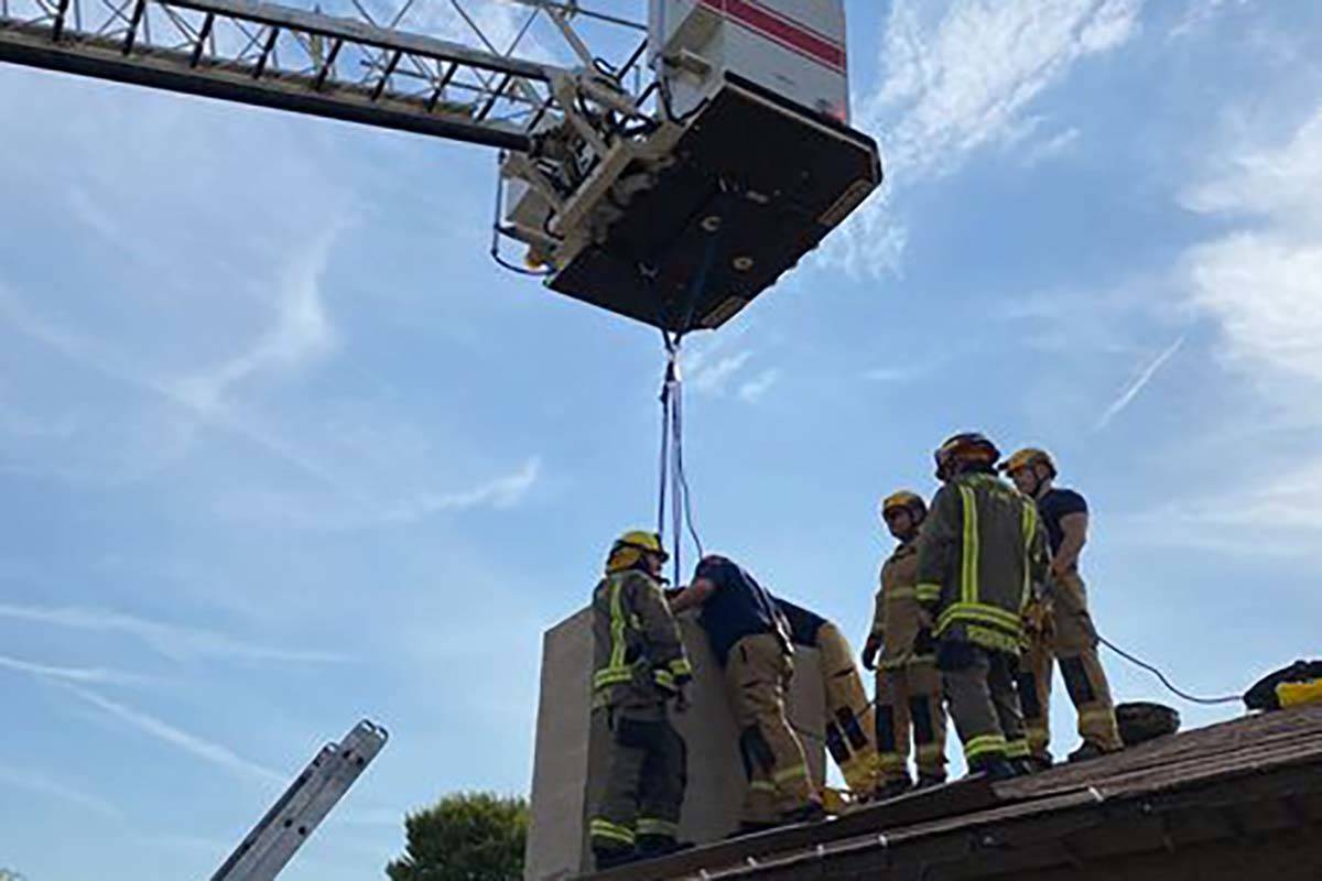 Henderson firefighters rescue an 18-year-old woman from the chimney of a home near Horizon Driv ...