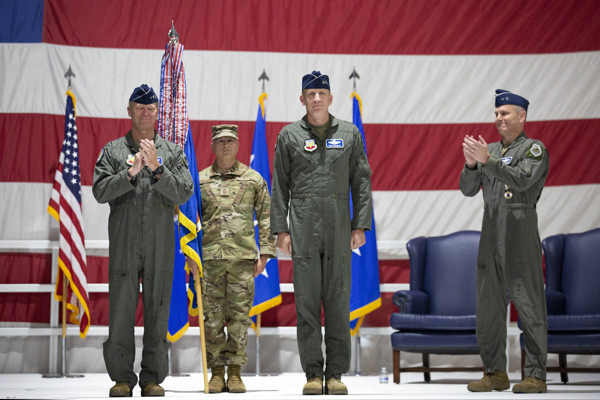 Gen. Mark Kelly, left, and Maj. Gen. Charles Corcoran, right, clap after command of the U.S. Ai ...