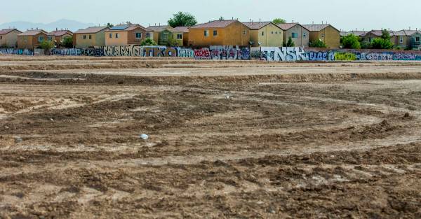 A graffiti-covered wall on the east side of the property still remains as construction begins o ...