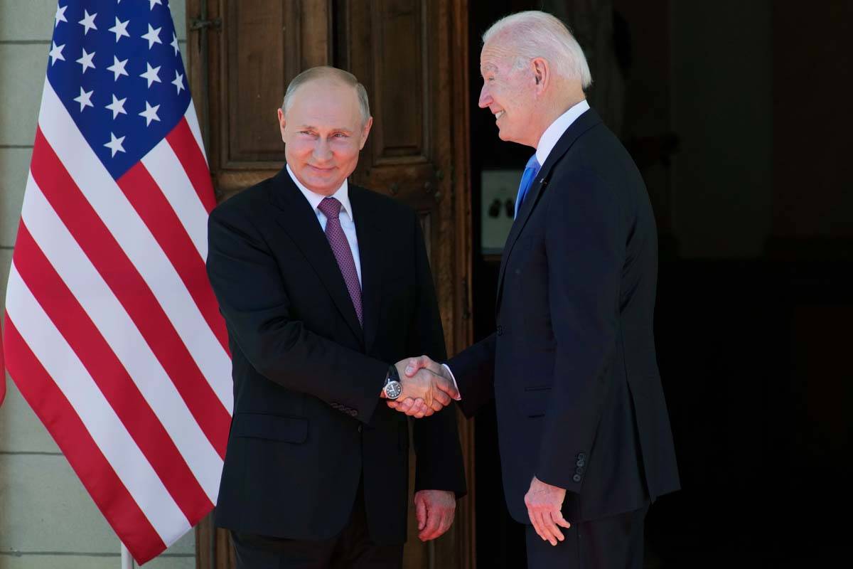 Russian President Vladimir Putin, left, and U.S President Joe Biden shake hands during their me ...
