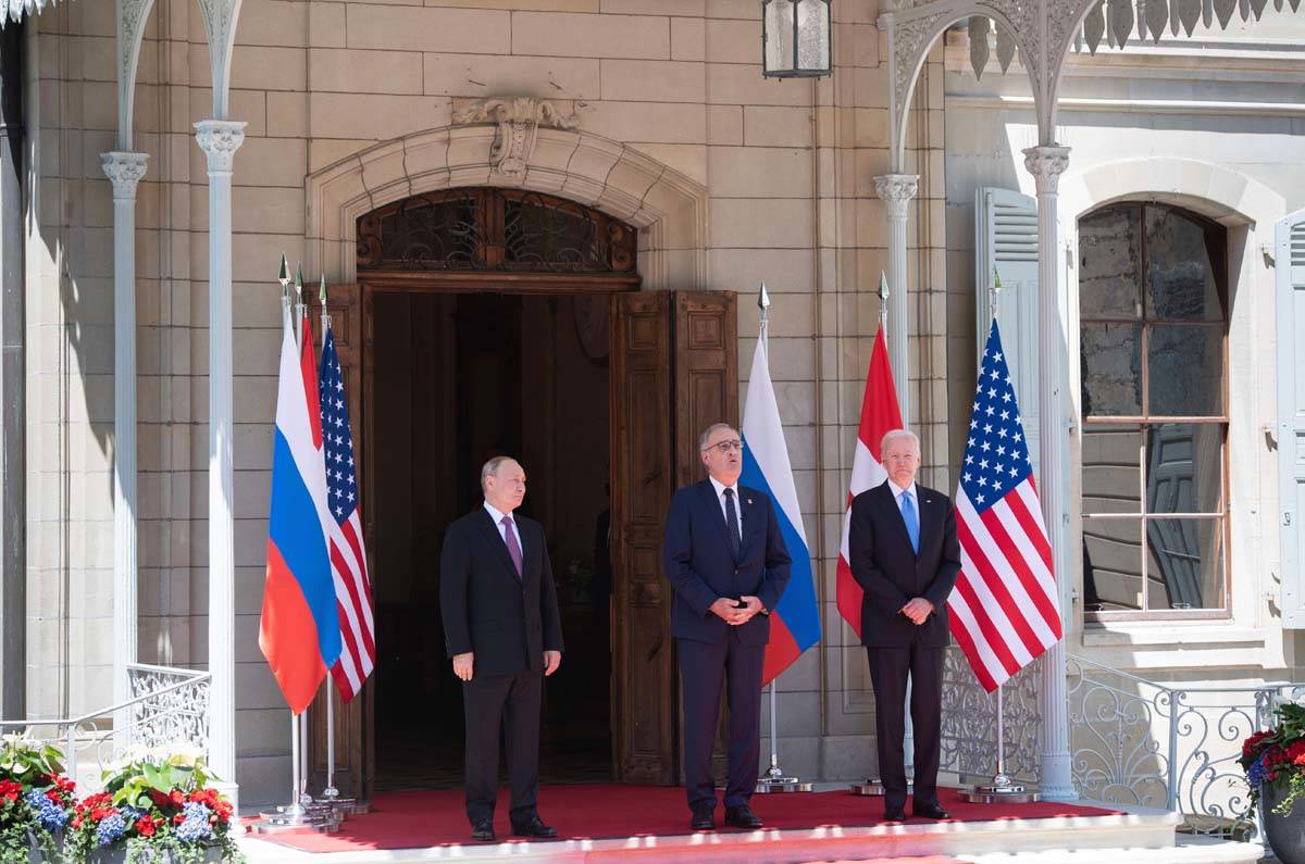 Swiss President Guy Parmelin, center, greets President Joe Biden, right, and Russian President ...