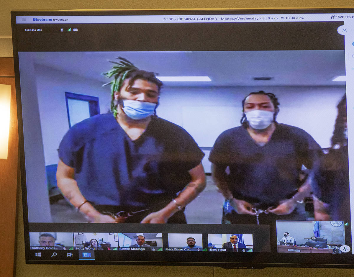 Dasean Williams, from left, and Marcus Parker, right, appear in court virtually for a hearing a ...