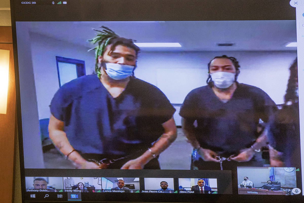 Dasean Williams, from left, and Marcus Parker, right, appear in court virtually for a hearing a ...