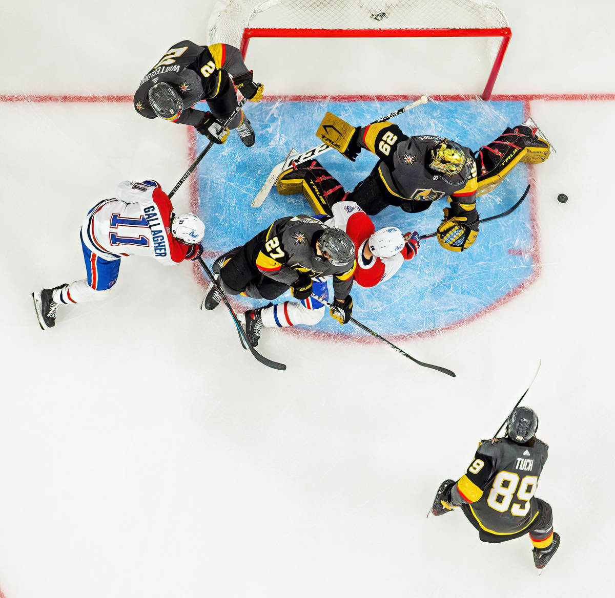 Golden Knights goaltender Marc-Andre Fleury (29) deflects a puck from Montreal Canadiens center ...