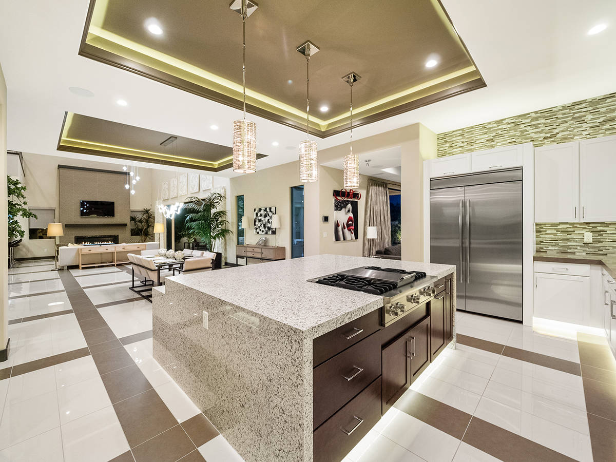 The kitchen features Viking appliances, a center island, separate bar seating and a wine room. ...