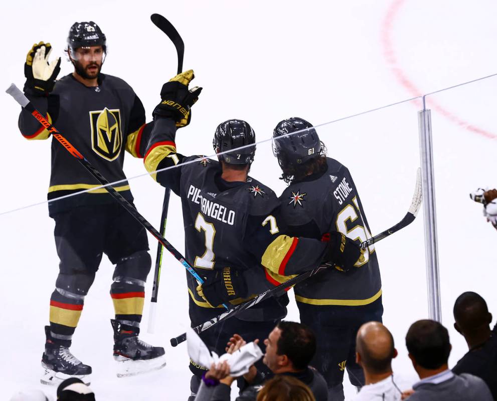 Golden Knights defenseman Alex Pietrangelo (7) celebrates his goal with Alec Martinez, left, an ...