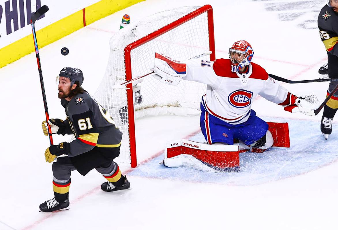 The puck flies over Golden Knights' Mark Stone (61) as Montreal Canadiens goaltender Carey Pric ...