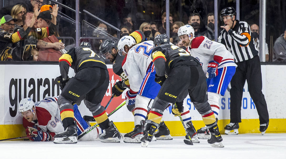 Montreal Canadiens right wing Corey Perry (94) is pummeled on the ice by Golden Knights right w ...