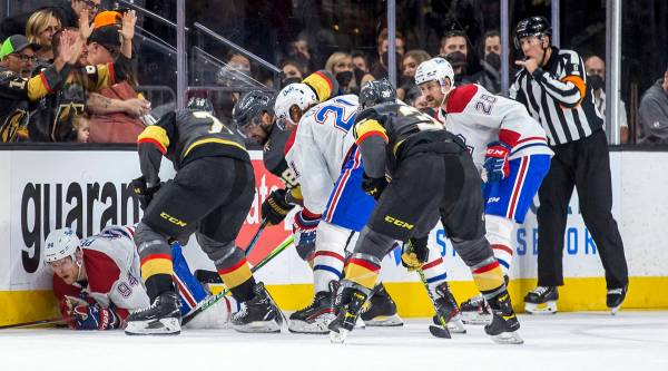 Montreal Canadiens right wing Corey Perry (94) is pummeled on the ice by Golden Knights right w ...