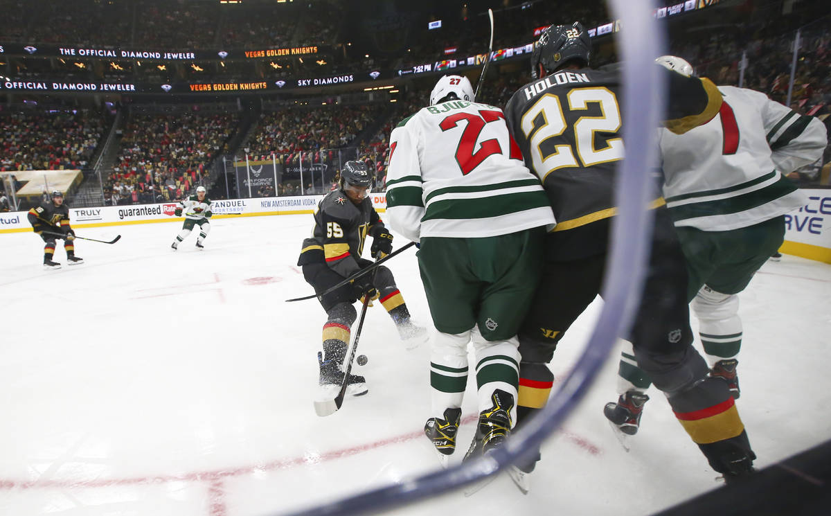 Golden Knights' Keegan Kolesar (55) battles for the puck against Minnesota Wild during the firs ...