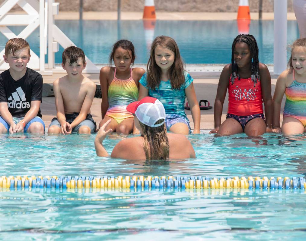 Children listen instructions form Katie Tyler, a volunteer instructor, prior to the start of th ...