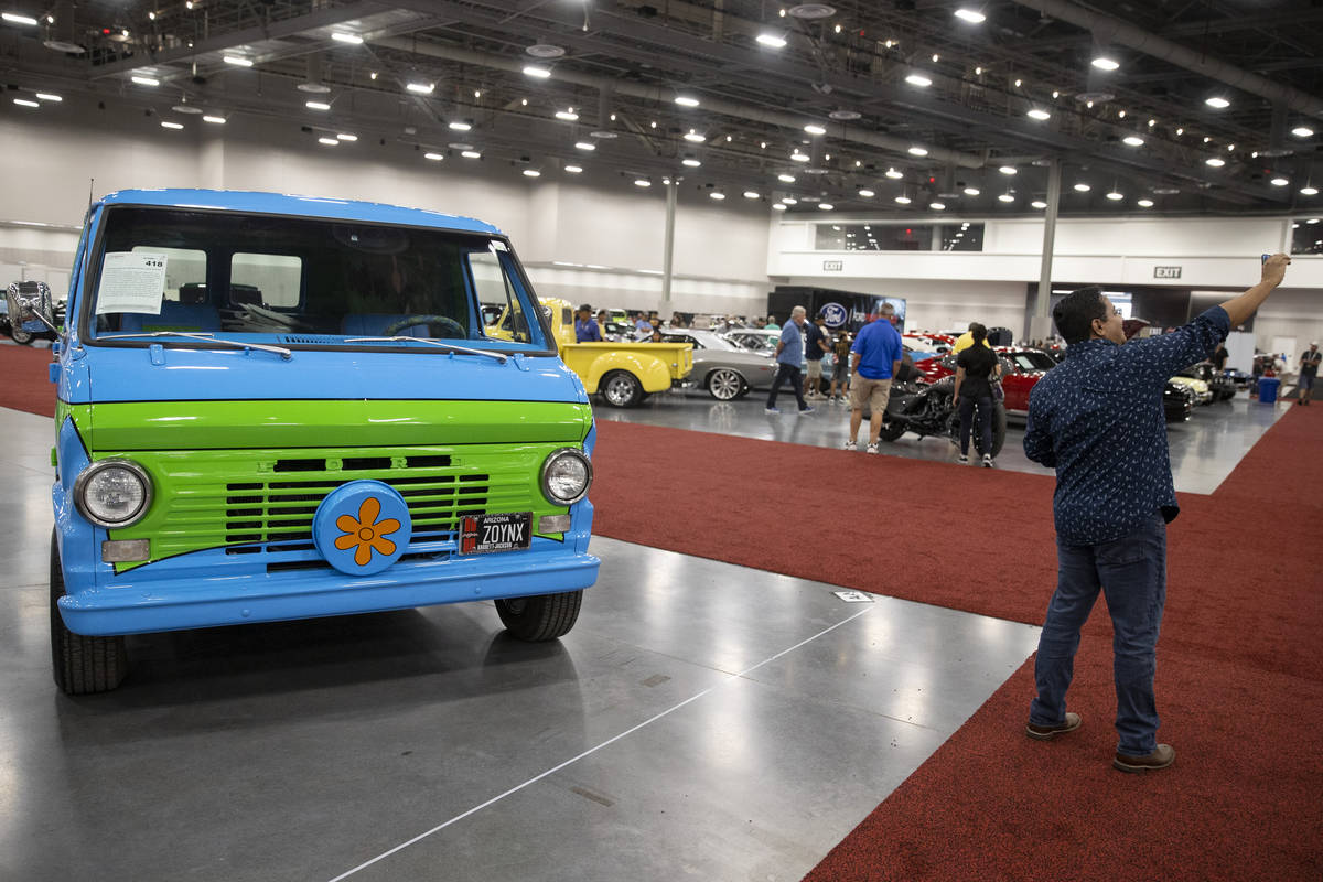 Alexander Vivas of Clombia takes a photo with the 1968 For Ecoline "Mystery Machine" ...