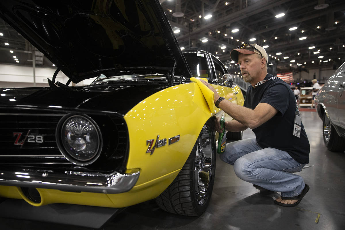 Dean Swan, of Idaho, polishes his 1969 Chevrolet Camaro custom coupe, showcased in the Barrett- ...