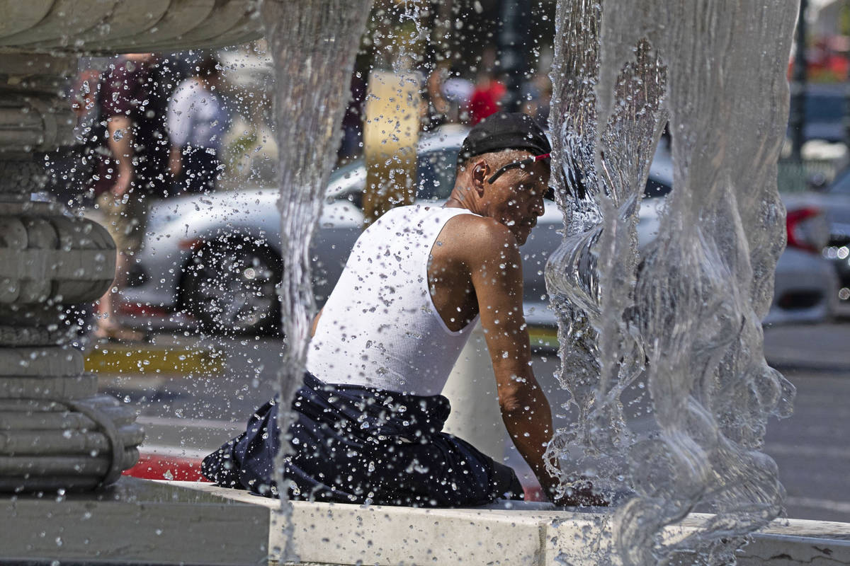 Darrick Washington takes a break next to the Venetian fountain, on Friday, June 18, 2021, in La ...