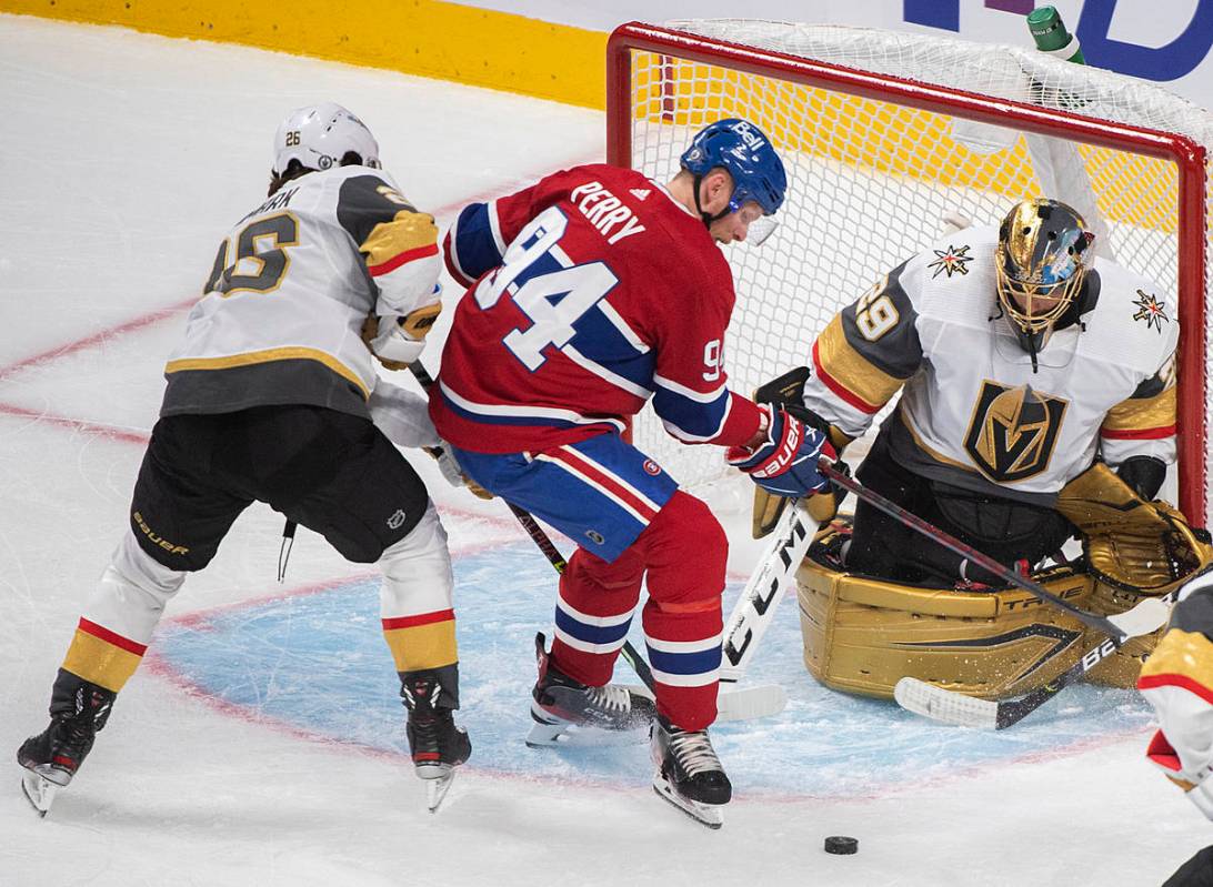 Montreal Canadiens' Corey Perry (94) moves in on Vegas Golden Knights goaltender Marc-Andre Fle ...