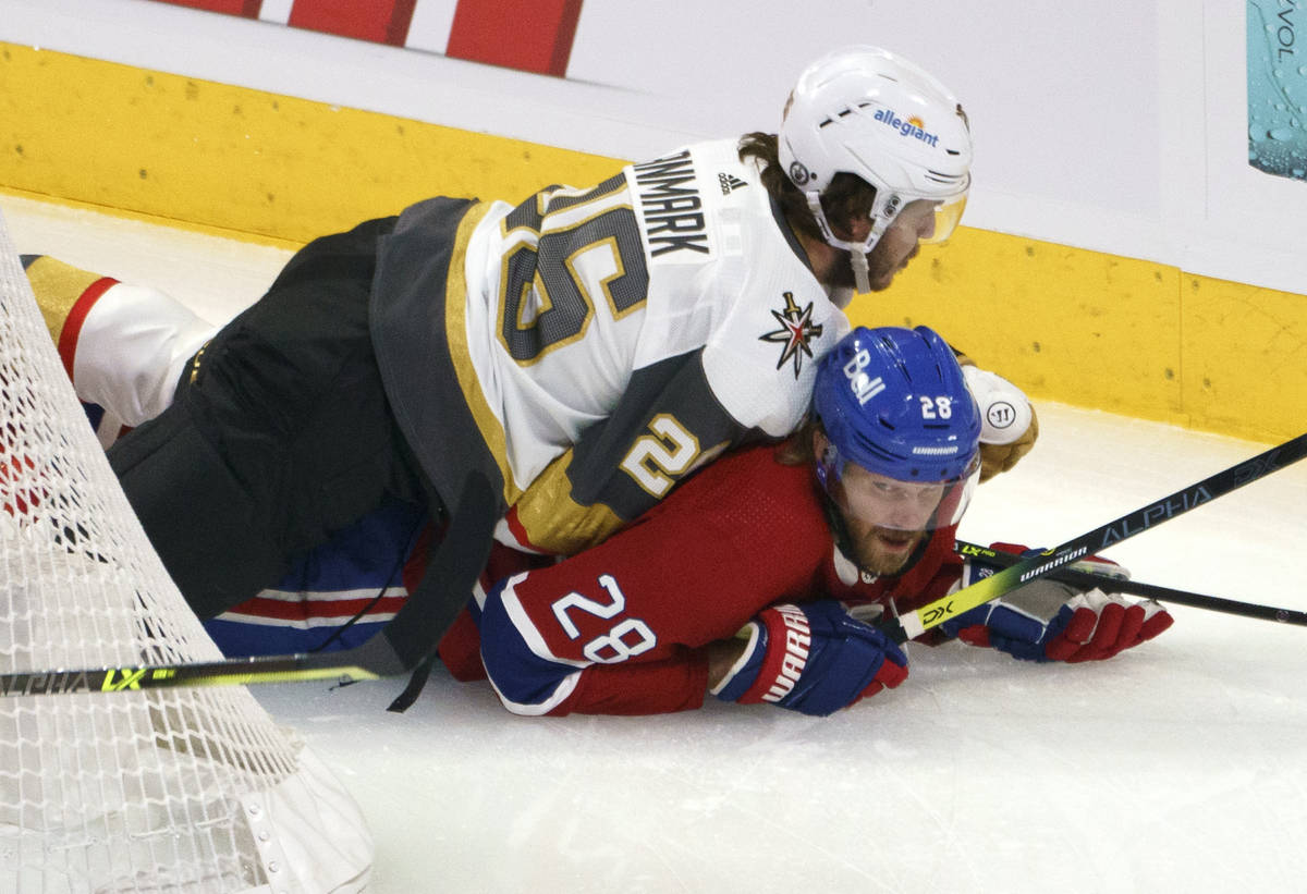 Vegas Golden Knights' Mattias Janmark falls onto Montreal Canadiens' Jon Merrill during the fir ...