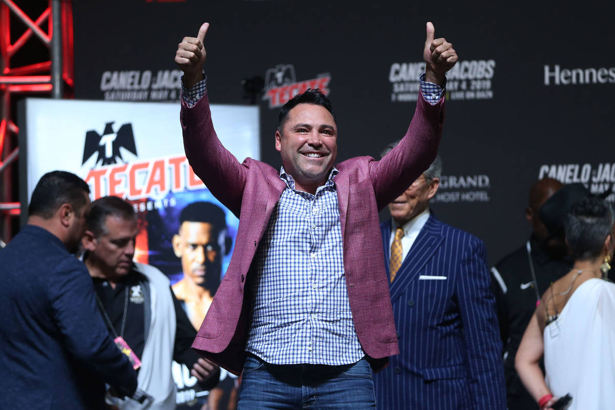 Boxing promoter Oscar De La Hoya reacts to fans during a weigh-in for Saul "Canelo" A ...