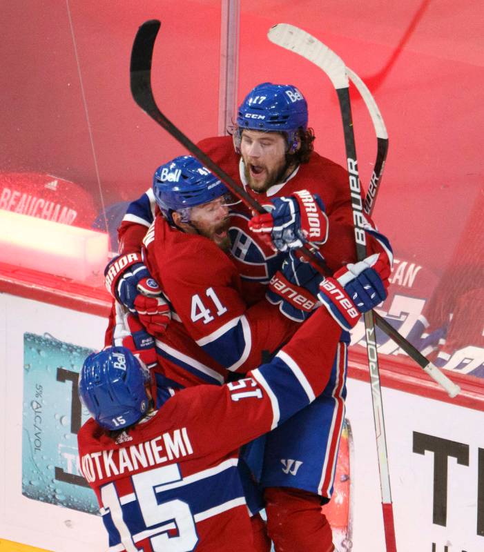 Montreal Canadiens' Josh Anderson (17) celebrates with Paul Byron and Jesperi Kotkaniemi after ...
