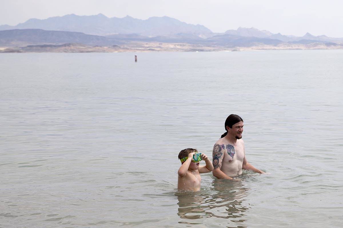 Noah Pratt, 5, and his father Ben Pratt, of Mississippi, cool off in the water along Boulder Be ...