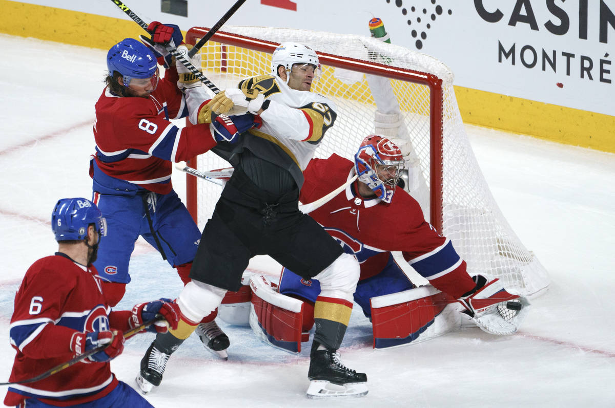 Vegas Golden Knights' Max Pacioretty is taken out by Montreal Canadiens defenseman Ben Chiarot ...