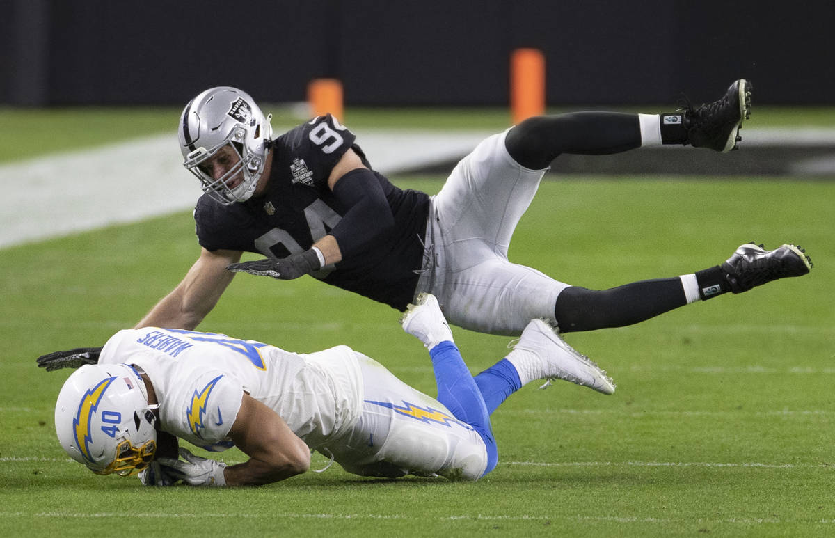 Raiders defensive end Carl Nassib (94) tackles Los Angeles Chargers fullback Gabe Nabers (40) i ...